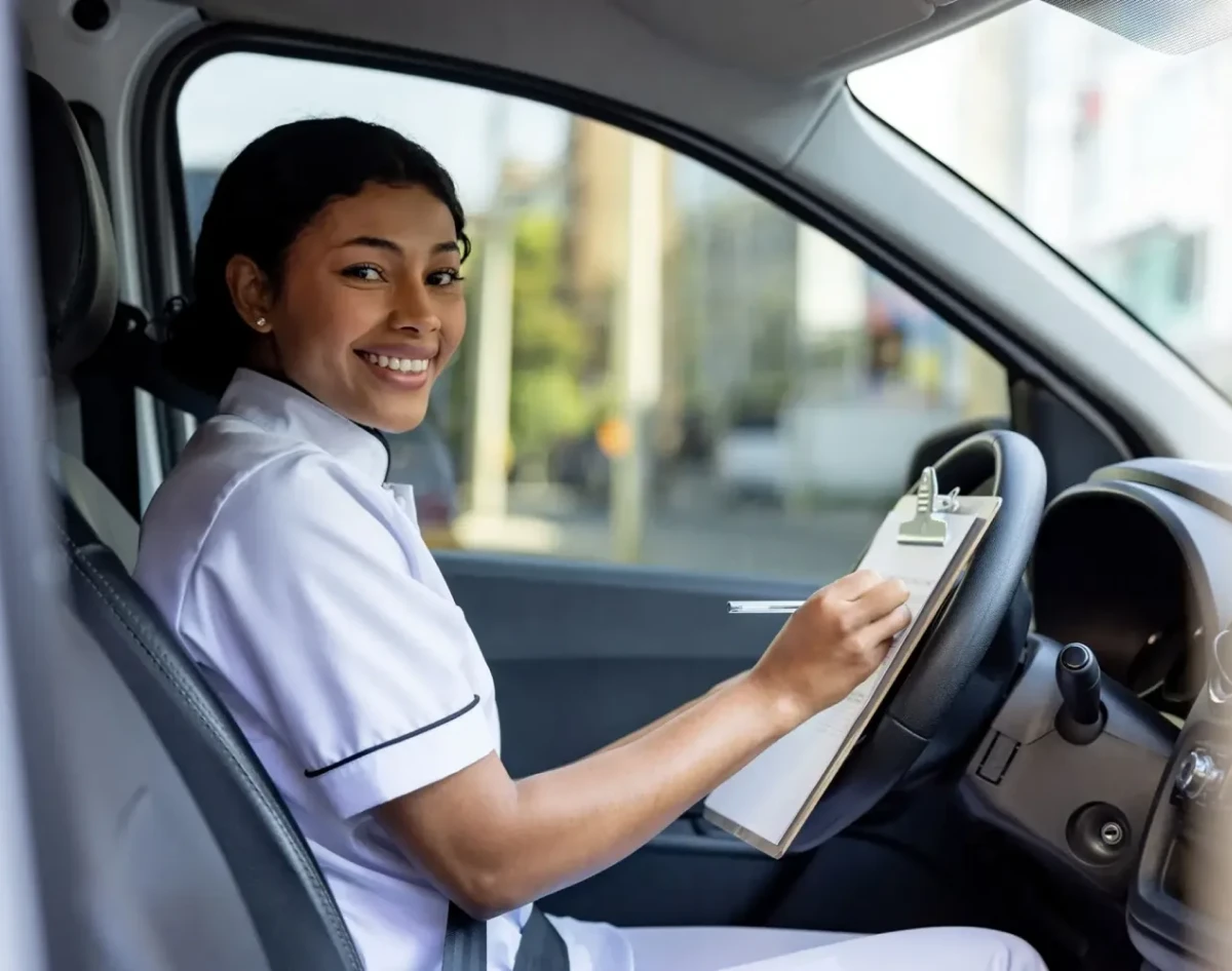 Nurse writing in vehicle