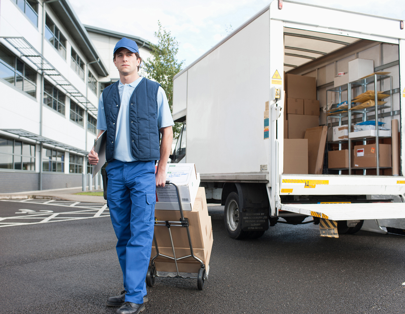 Delivery person with package trolley